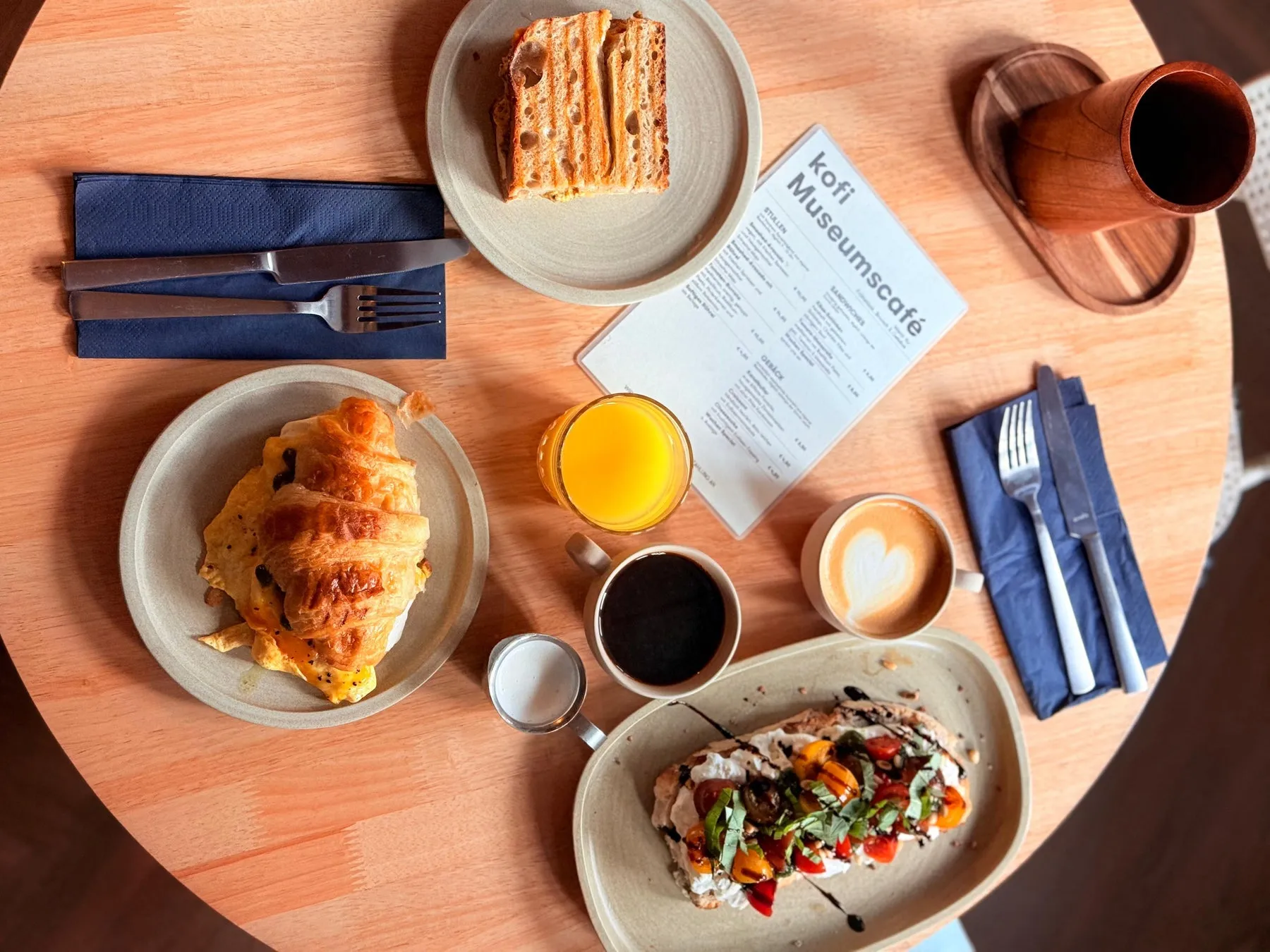 Frühstück im kofi Museumscafé: Croissant mit Rührei, Tomaten-Burrata-Stulle, Cappuccino und Orangensaft